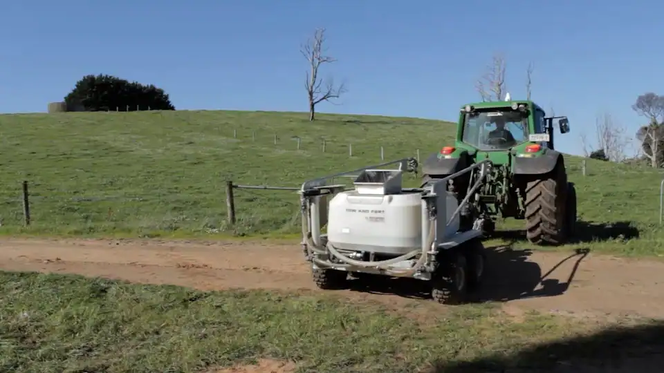 Tow and Fert being towed by tractor on a farm track, Mirboo North